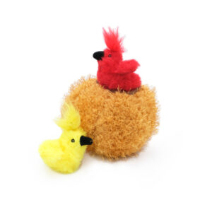 Two ZippyClaws® Burrow® - Birds in Nest, one red and one yellow, sit on and next to a fuzzy, round, orange object. The red bird is perched on top while the yellow bird is on the ground.