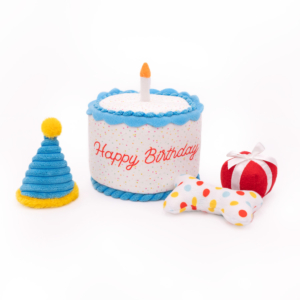 A Zippy Burrow® - Birthday Cake, a polka-dotted bone, a red and white striped gift, and a blue and yellow party hat are arranged on a white background.