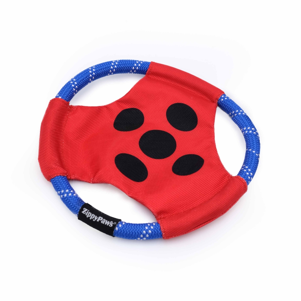 A round, red and blue dog toy with four black spots and a 