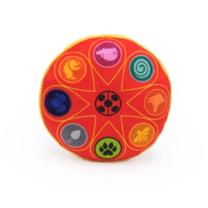 A round, bright red Miraculous Squeakie Pattiez - Miracle Box with yellow trim featuring symbols of various animals and elements arranged in a circular pattern.
