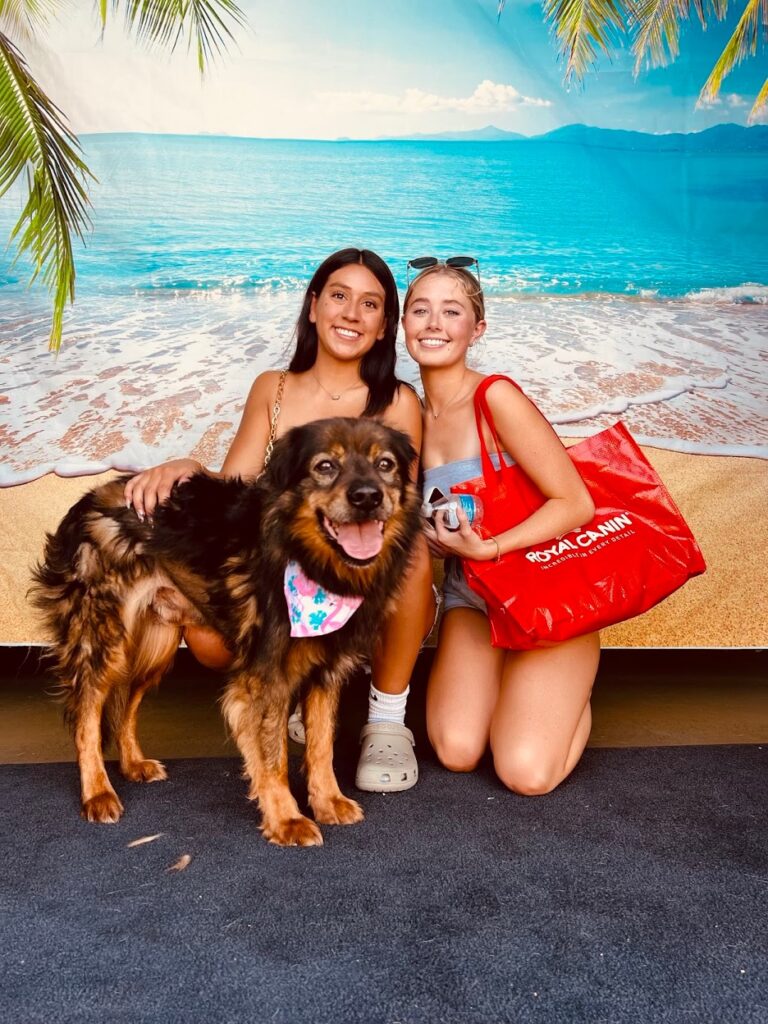 Two women posing with adopted dog