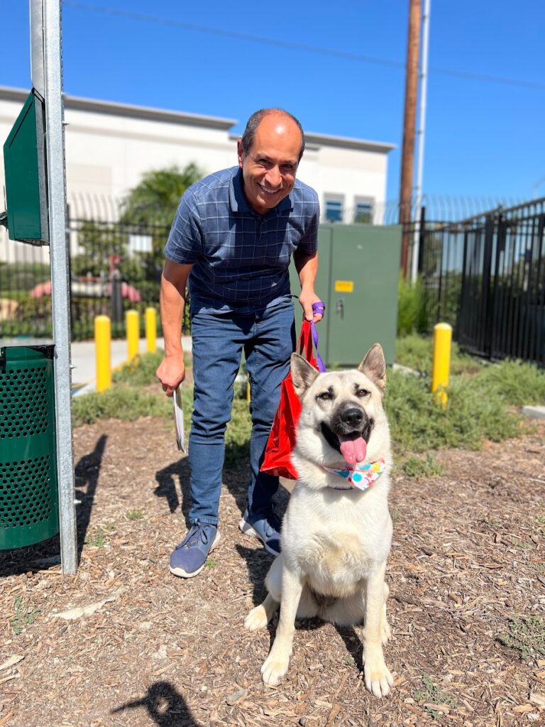 Man posing with adopted dog