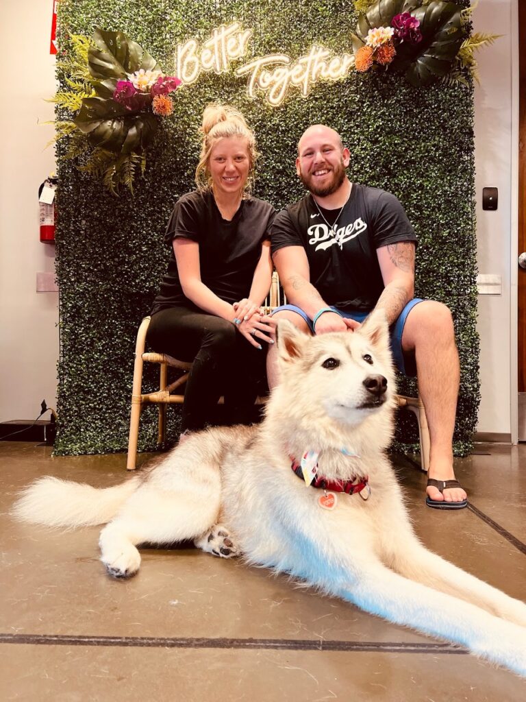 Man and woman posing with adopted dog