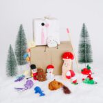 Display of Cat toys in front of snowy back drop and christmas presents