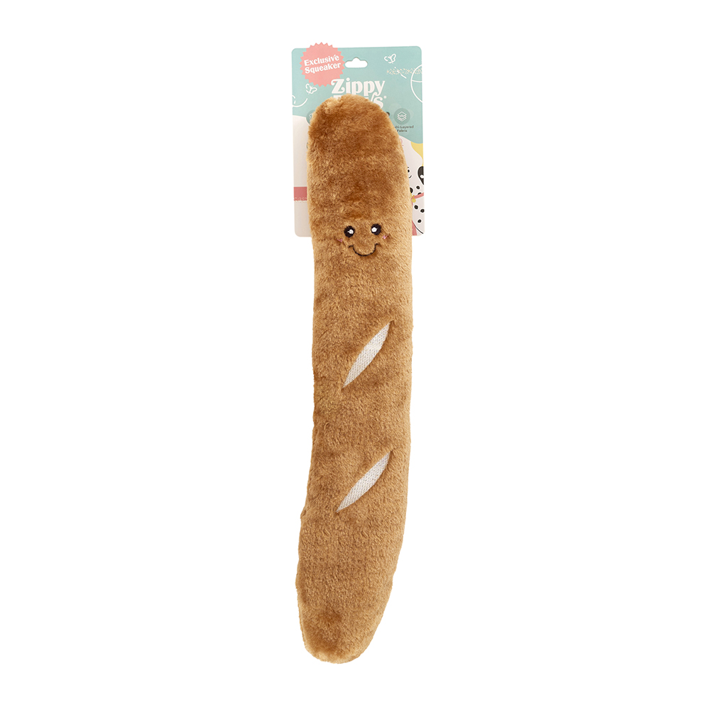 A plush dog toy shaped like a rocket pop from the Jigglerz® line, featuring a smiling face and two white marks, with its packaging attached at the top.