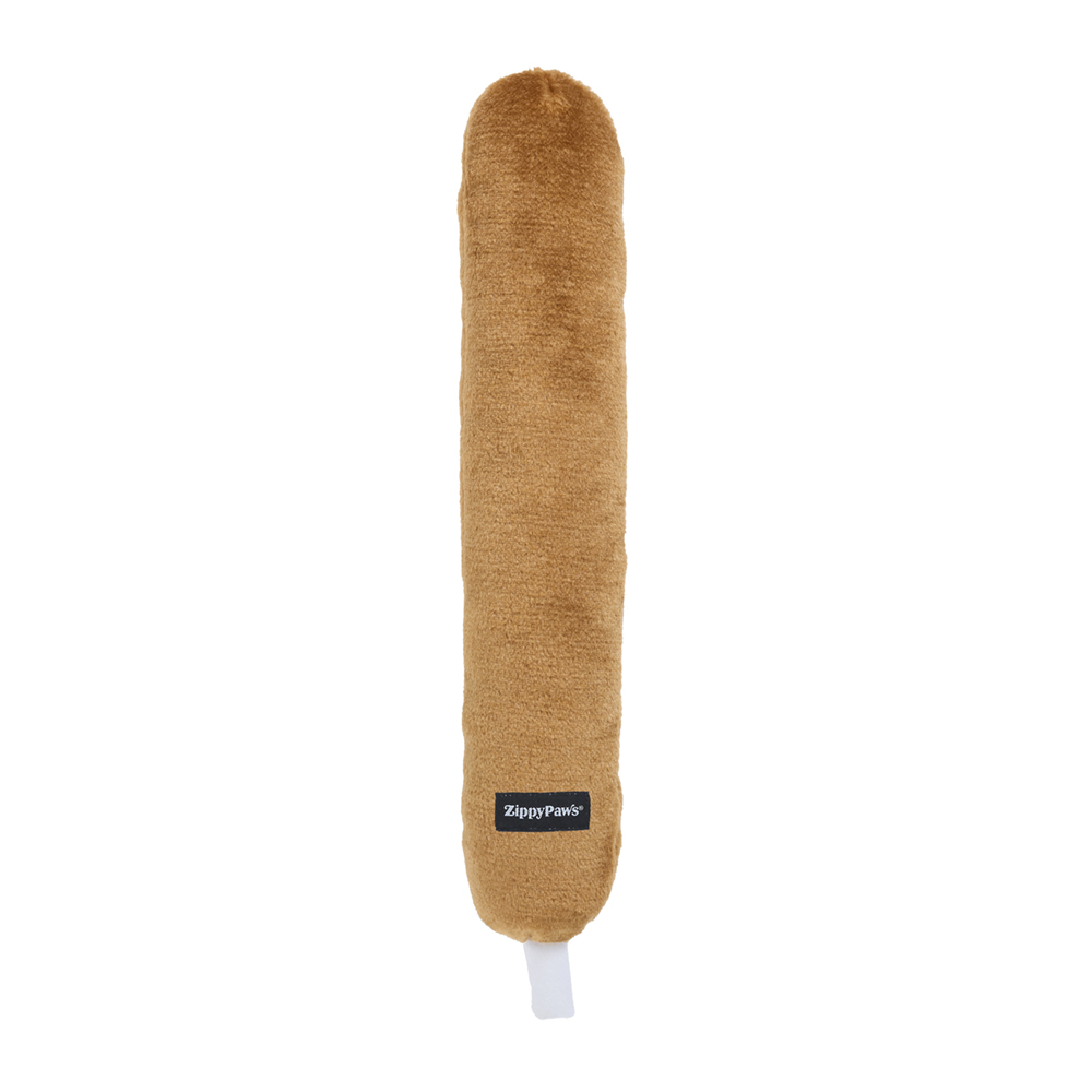 Jigglerz® - Corn Dog is a plush toy shaped like a brown corn dog, featuring a small fabric tag that says "ZippyPaws" and a white fabric loop at one end.