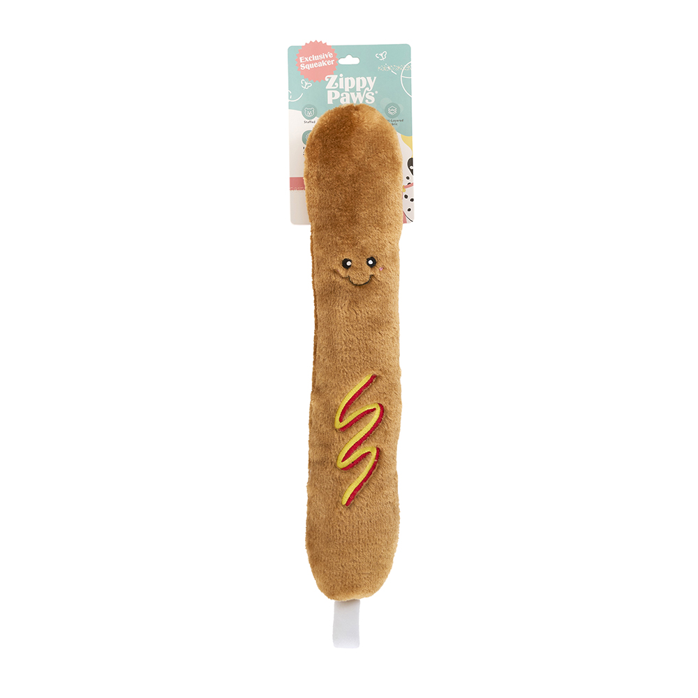 A plush dog toy shaped like a rocket pop with embroidered details and a smiling face, labeled “Jigglerz® - Rocket Pop.”.