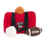 A Zippy Burrow® - Zippy Meal plush toy, designed as a red sports bag with black straps and a logo, is surrounded by plush toy versions of a basketball, baseball, and football.