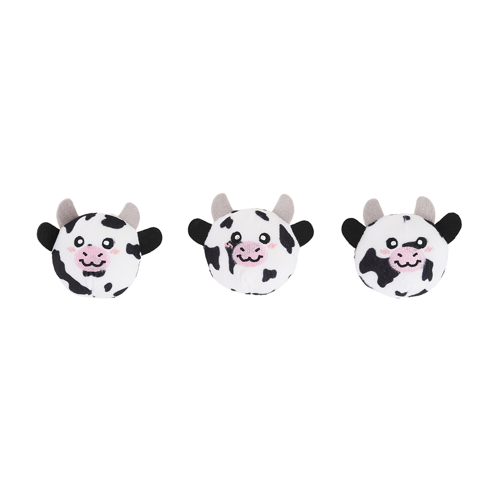 Three round Zippy Burrow® - Zippy Meal plush toys, shaped like cows with black and white spots, pink cheeks, and small horns, are lined up against a white background.