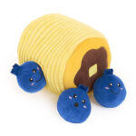 A Zippy Burrow® - Zippy Meal featuring a yellow plush log with a brown end, surrounded by three blue plush berries with smiling faces.