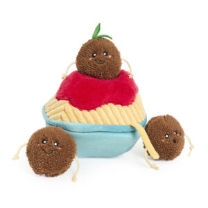Three plush brown balls with smiling faces—one perched atop the red and yellow Zippy Burrow® - Zippy Meal cupcake-shaped plush, and two positioned in front—all featuring string arms and legs.