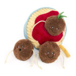 Three Zippy Burrow® - Zippy Meal plush toy meatballs, two with string “arms” and one sitting on a soft, plush plate of spaghetti and red sauce, all featuring small embroidered faces.