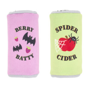 Two plush cylindrical toys: a pink one labeled “Berry Batty” with bats and strawberries, and a green one labeled “Spider Cider” with a spider, web, and apple.